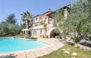 a large house with a swimming pool in the yard at Lovely Home In Le Tignet With Outdoor Swimming Pool in Le Tignet
