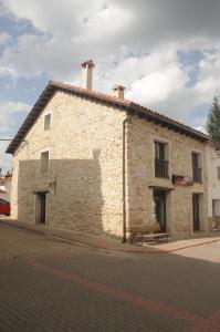 a brick building on the side of a street at EL VASALLO 2 in Tragacete