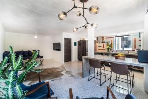 a kitchen and living room with a large table and chairs at Cuale in Puerto Vallarta