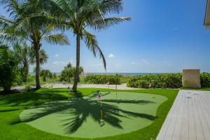 a golf course with palm trees and a putting green at Casey Key Resorts - Beachfront in Venice