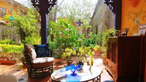 a patio with a table and some plants at Casa Montalvo Bed & Breakfast in Cuenca