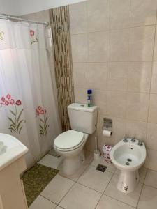 a bathroom with a white toilet and a sink at Edificio Rivera Este in Colón +36 photos
