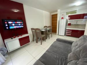 a living room with a kitchen and a dining room at Israel Flat Tambaú in João Pessoa +13 photos