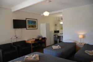 a hotel room with two beds and a kitchen at Angaston Vineyards Motel in Angaston