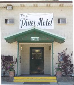 
a building with a sign on the front of it at The Pines Motel in Saint Maries
