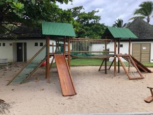 a playground with a swing set in the sand at Beach Class Park 02 Quartos in Porto De Galinhas