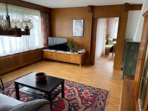 a living room with a couch and a table at Dahoam in Imst
