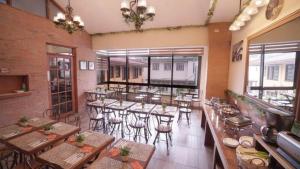 a restaurant with tables and chairs in a room at 1775 Adriatico Suites in Manila