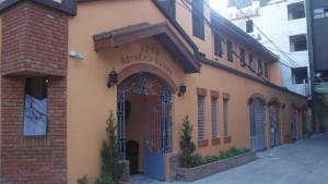 a building with a gate on a street at 1775 Adriatico Suites in Manila