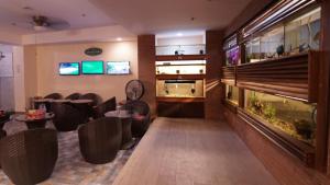 a restaurant with a fish tank in a room at 1775 Adriatico Suites in Manila