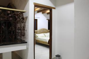 a bedroom with a mirror and a bed in it at Casa Bella in Villa de Leyva
