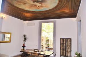 a dining room with a ceiling with a painting at Ronda Sant Pere Rafael in Barcelona