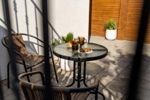 a table with a plate of food on a patio at Corvin Guesthouse in Hunedoara
