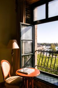 a wooden chair sitting in front of a window at Auberge du Vieux Port in Montreal