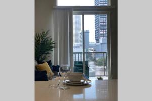 a table with two wine glasses and a table with a view at Downtown Houston Condo w Pool and Free Parking 6 in Houston