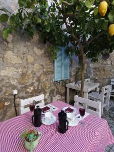 a table with a red and white checkered table cloth at kaktüshan otel in Alaçatı