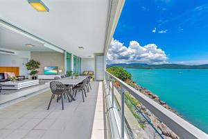 a view from a balcony of a restaurant with a view of the ocean at Peninsula Airlie Beach in Airlie Beach