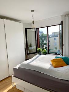 1 dormitorio con 1 cama grande y ventana grande en Modern, gemütlich, sehr zentrumsnah & ruhig en Leipzig