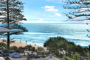 a view of a beach with cars parked on it at Coolum Beachside Studio in Coolum Beach