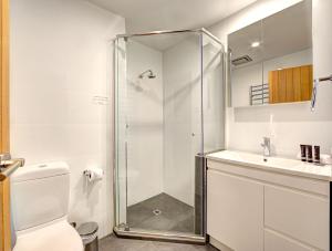 a bathroom with a shower and a toilet and a sink at Snow Ski Apartments 36 in Falls Creek