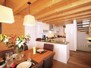 uma cozinha e sala de jantar com uma mesa e um balcão em Lavish Holiday Home in H r mence with Balcony em Hérémence