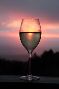 a glass of wine with the sunset in the background at Green Acres B&B in Beechmont