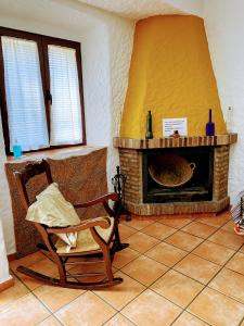 - un salon avec une chaise et une cheminée dans l'établissement El Antiguo Molino, à El Bosque