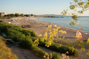 a beach with a bunch of boats in the water at Holiday Village Lozenets in Lozenets