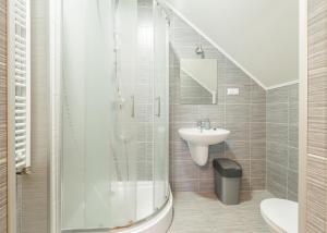 a bathroom with a shower and a sink at Willa Nova in Polańczyk