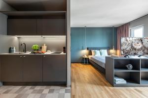 a kitchen and a bedroom with a bed at ipartment Braunschweig in Braunschweig