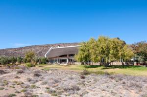 a house in the middle of a field at Sanbona Wildlife Reserve in Barrydale