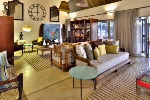 a living room with a couch and a table at Sanbona Wildlife Reserve in Barrydale