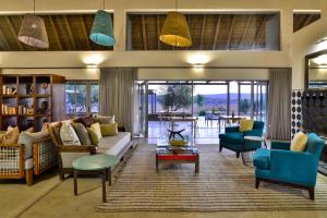 a living room with a couch and chairs and a table at Sanbona Wildlife Reserve in Barrydale