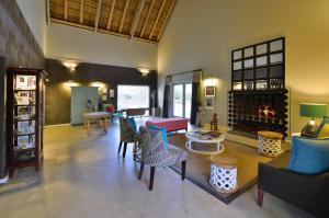 a large living room with chairs and a fireplace at Sanbona Wildlife Reserve in Barrydale