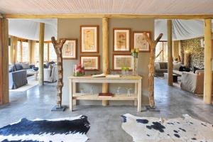 a living room with a table in the middle at Sanbona Wildlife Reserve in Barrydale
