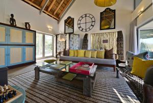 a living room with a couch and a table at Sanbona Wildlife Reserve in Barrydale