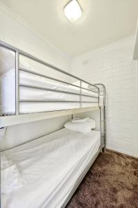 a bedroom with two bunk beds in a room at Snow Ski Apartments 12 in Falls Creek