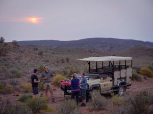 a group of people standing next to a jeep at Sanbona Wildlife Reserve in Barrydale