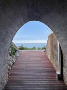 a tunnel leading to a walkway under a bridge at Donghae Oceancity Residence Hotel in Donghae
