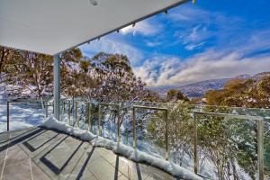 a glass house with a view of the mountains at Snow Ski Apartments 18 in Falls Creek