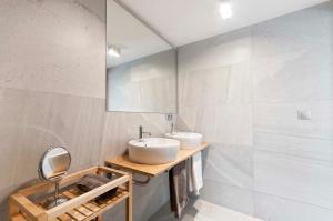 a bathroom with two sinks and a mirror at AticoColón21 in Alicante +19 photos