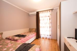 A bed or beds in a room at Holiday Village Lozenets