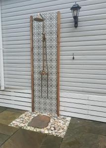 a building with a door with a stone wall at Treehouse - Hot Tub in Newton on the Moor