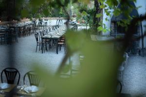 a row of tables and chairs in a restaurant at A Casa Da Angelo - Country House PrivatePool & AirCO in Grottammare