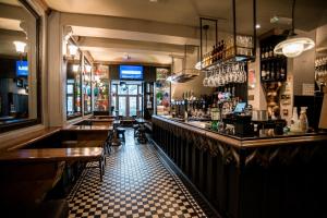 a bar with a black and white checkered floor at Lower Turks Head in Manchester