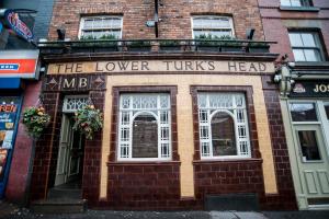 a brick building with a sign that reads the lower turns head at Lower Turks Head in Manchester