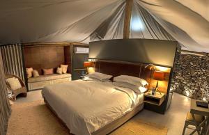 a bedroom with a large bed in a tent at Sanbona Wildlife Reserve in Barrydale