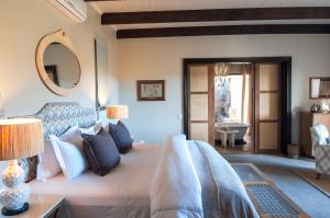 a bedroom with a large bed and a mirror at Sanbona Wildlife Reserve in Barrydale
