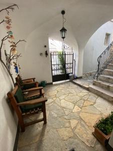 a living room with chairs and a stone floor at Apartments Getruda in Krk