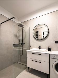 a bathroom with a sink and a mirror at Apartament 117 - Rezydencja Niechorze in Niechorze